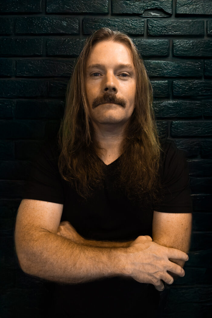 Sean Bolton AKA Scan Boltron on a photoshop AI Background bricks