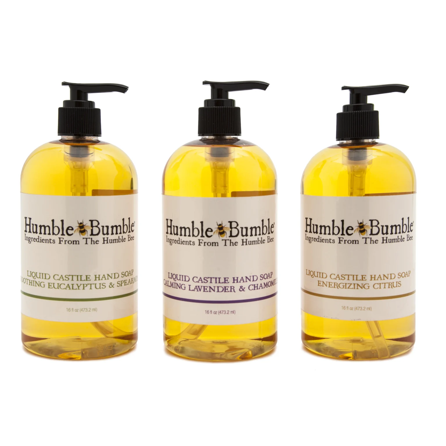 Commercial product photograph of three amber pump bottles of Humble Bumble Liquid Castile Hand Soap arranged in a row on a seamless white background.